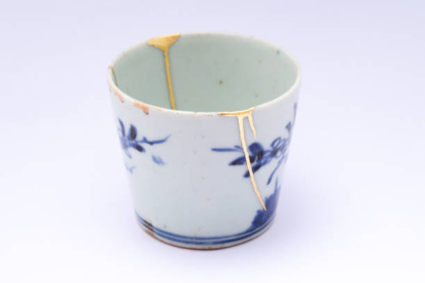 istock Kintsugi Antique broken Japanese cup repaired with gold. 1280370301