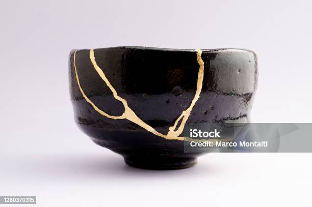 Antique Broken Japanese Raku Black Bowl Repaired With Gold Kintsugi Technique Stock Photo - Download Image Now