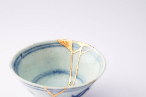 istock Kintsugi bowl Antique broken Japanese pottery repaired with gold. 1280370364