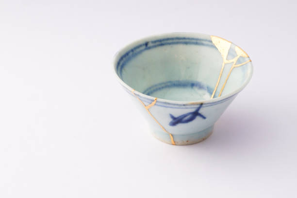 istock Kintsugi bowl Antique broken Japanese pottery repaired with gold. 1280370365