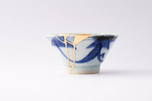 istock Kintsugi bowl Antique broken Japanese pottery repaired with gold. 1280370368