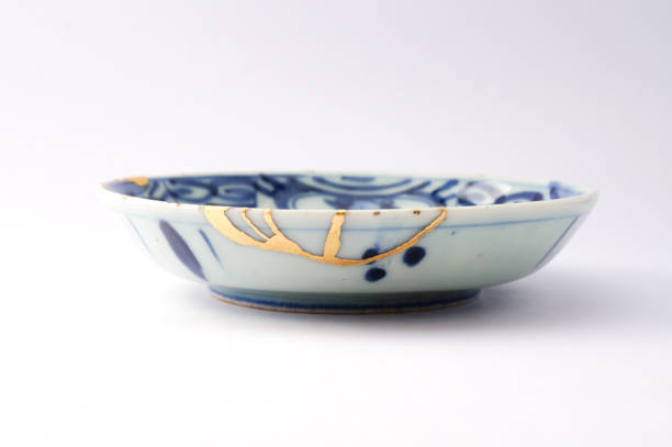 istock Kintsugi Antique broken Japanese plate repaired with gold. 1280370393
