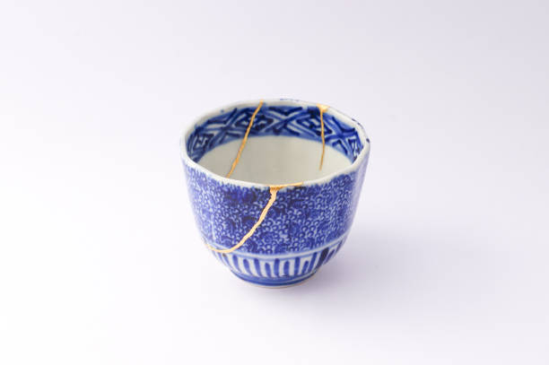 istock Kintsugi Antique broken Japanese cup repaired with gold. 1280370417