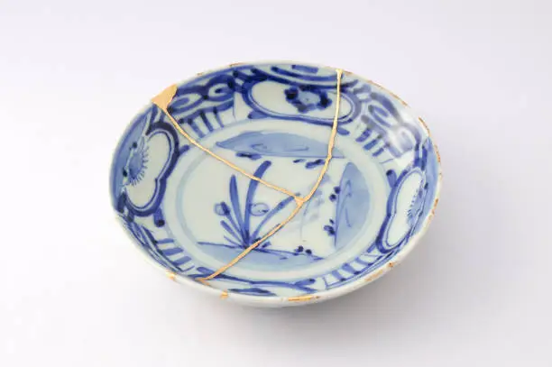 Photo of Antique broken Japanese plate repaired with gold kintsugi technique