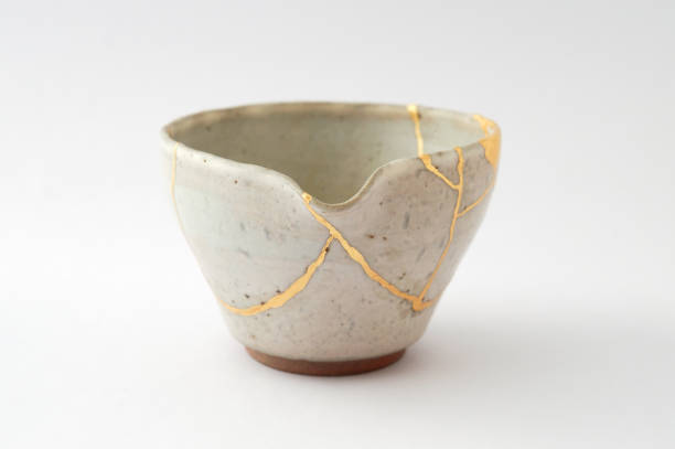 istock Antique broken Japanese beige teapot repaired with gold kintsugi technique 1280370520