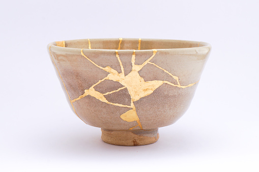 Antique broken Japanese beige bowl repaired with gold kintsugi technique