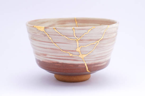 istock Antique broken Japanese beige bowl repaired with gold kintsugi technique 1280370735