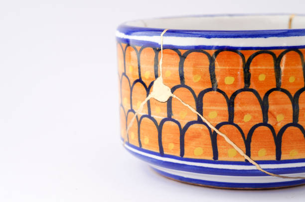 Kintsugi blue and white bowl. Gold cracks restoration on old Italian pottery restored with the antique Kintsugi restoration technique. The beauty of imperfections. japanese pottery repair gold. japanese art of repairing cracks with gold. japanese art of fixing broken pottery