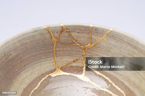 Antique Broken Japanese Beige Bowl Repaired With Gold Kintsugi Technique Stock Photo - Download Image Now
