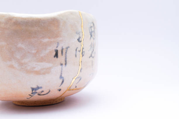istock Antique broken Japanese beige bowl repaired with gold kintsugi technique 1280373225