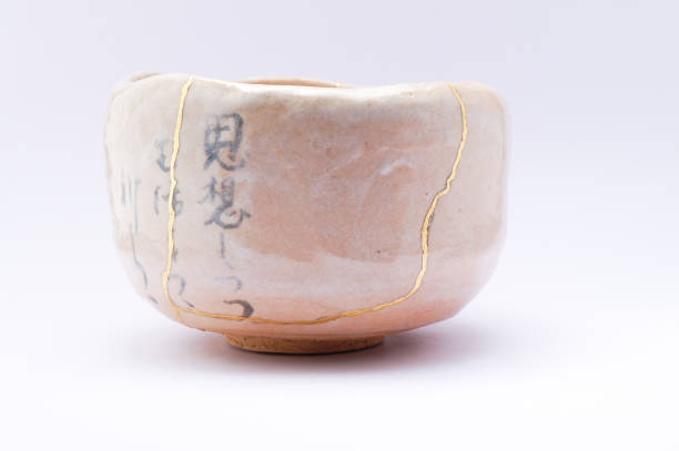 istock Antique broken Japanese beige bowl repaired with gold kintsugi technique 1280373248