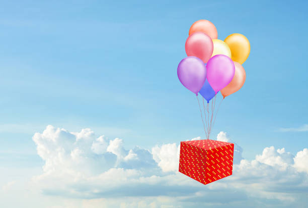 istock Colorful balloons and a red gift box on the bright sky 1280373625