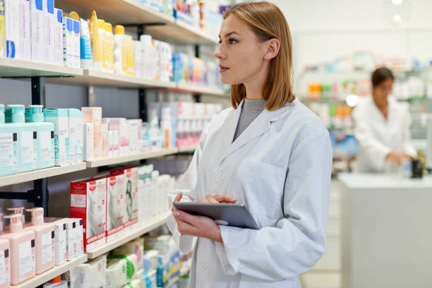 istock Russian female pharmacist taking inventory on a digital tablet 1280374578