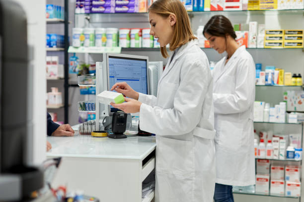 istock One young pharmacist reading a medicine's box label 1280374610