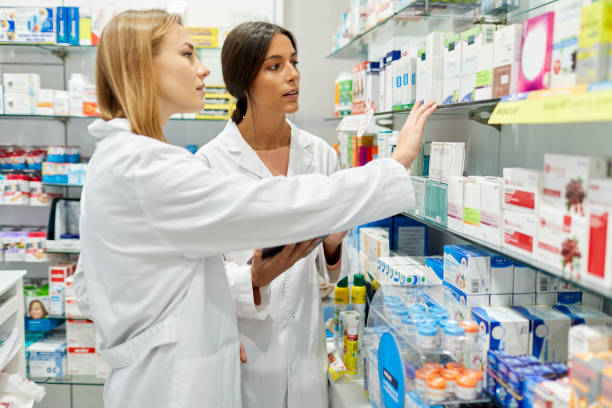 istock Two female pharmacists organizing medicines on the shelves 1280374625