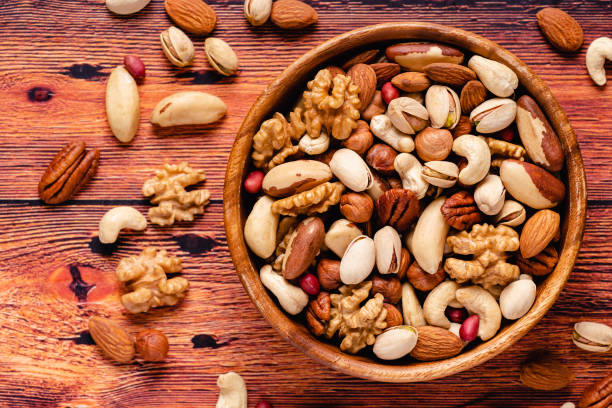 istock Various Nuts in wooden bowl 1280376466