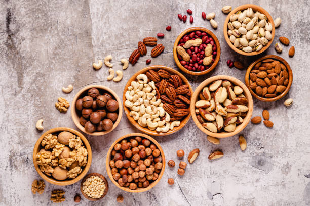 istock Various Nuts in wooden bowls 1280376588