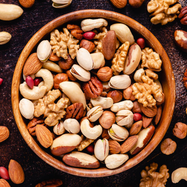 istock Various Nuts in wooden bowl 1280376591