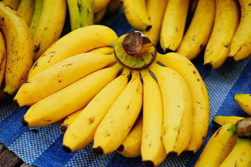 Fresh bananas on wooden background, top view