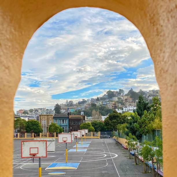 View of Noe Valley Neighborhood in San Francisco A view of the Noe Valley neighborhood in San Francisco through a yellow arch. noe valley san francisco stock pictures, royalty-free photos & images
