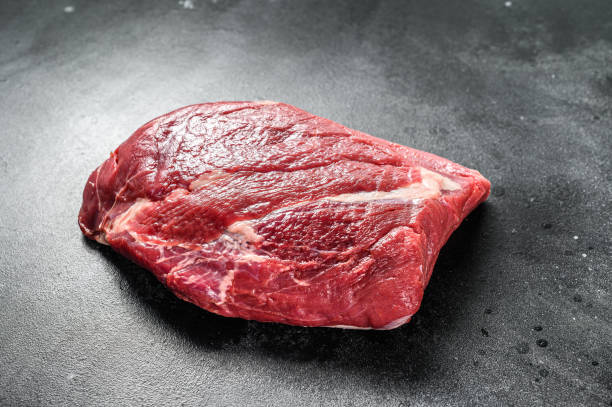 istock Raw brisket beef cut. Black Angus beef. Black background. Top view. 1280378943