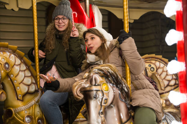 istock Two happy female friends riding on carousel 1280379270