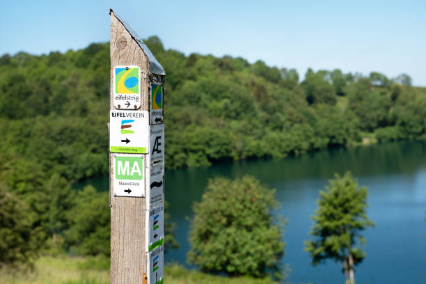 Schalkenmehren, Germany - June 23, 2020: Long distance hiking trail Eifelsteig with focus on the typical waymark on June 23, 2020 in Germany