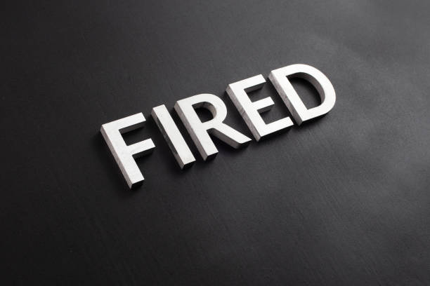 istock the word fired laid with white brushed metal letters on flat black surface 1280380452