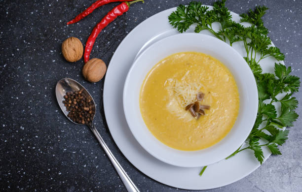 istock yellow pumpkin soup with mushrooms in a plate on the table 1280382481