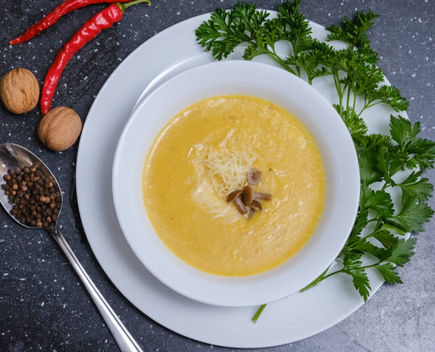istock yellow pumpkin soup with mushrooms in a plate on the table 1280382505