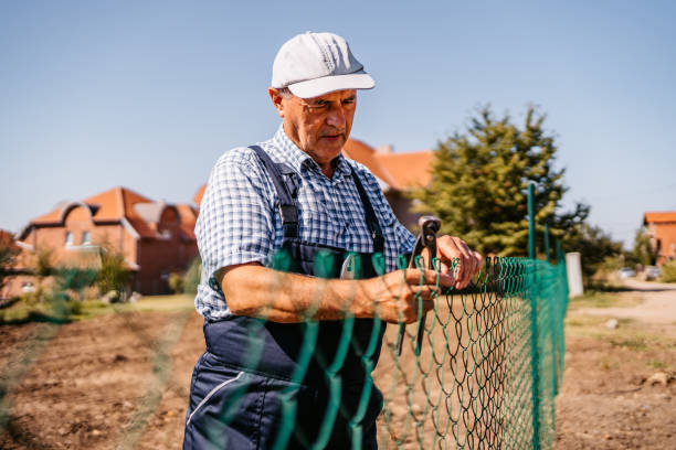 istock Senior man building fence 1280382700