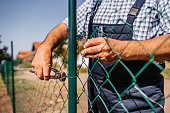 Senior man building fence