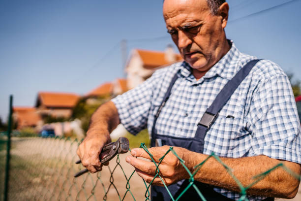 istock Senior man building fence 1280382827