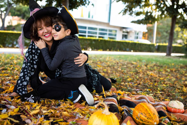 A cute boy hugging his grandma after trick-or-treating stock photo