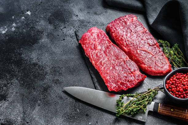 istock Marble beef Denver steak with herbs. Organic meat. Black background. Top view. Copy space 1280383071