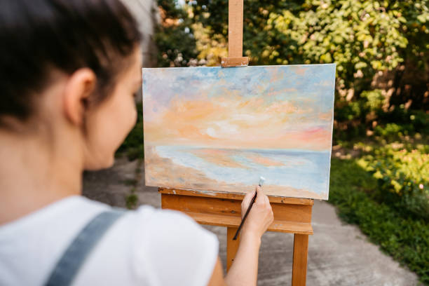 istock Female artist painting in backyard 1280384082