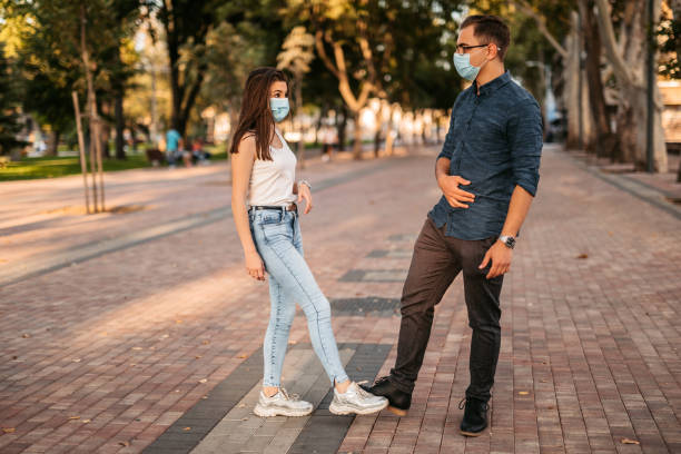 istock Couple greeting with foot bump on date 1280384417