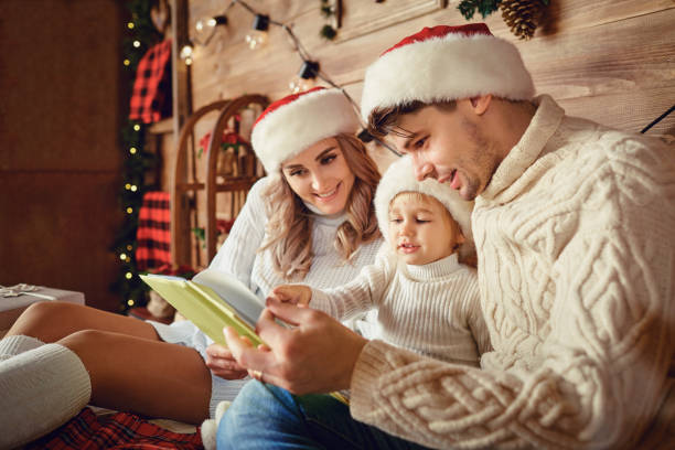 istock Happy family reading a book  at Christmas. 1280385277