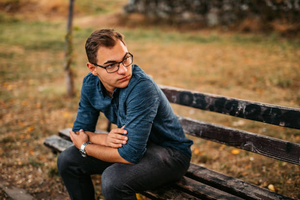 istock Nervous man sitting on bench in park 1280385567
