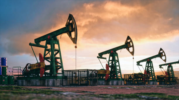Working Pumpjacks On Sunset Working oil pumps against a sunset sky. mining natural resources photos stock pictures, royalty-free photos & images
