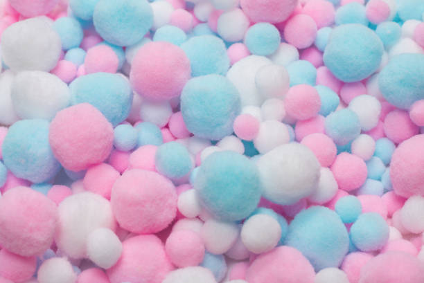 istock White, pink and blue soft pom poms. 1280386014