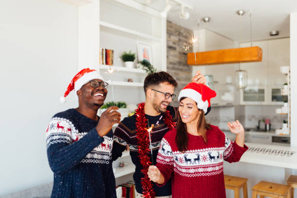 istock Three friends celebrating winter holidays at home together 1280386613