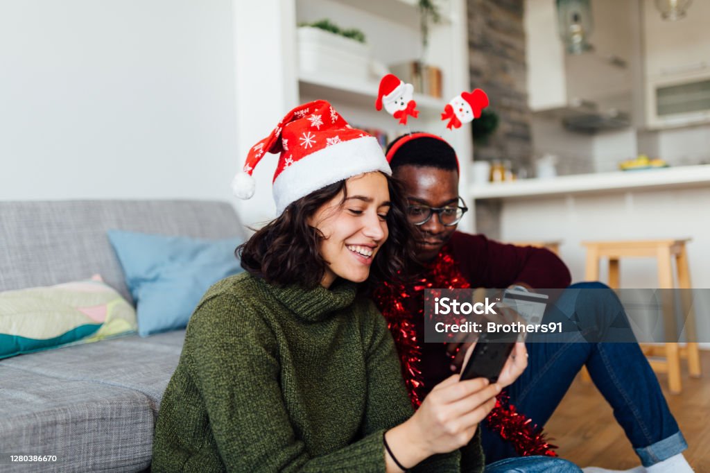 Happy Interracial Couple Shopping From Home With Smart Phone And A