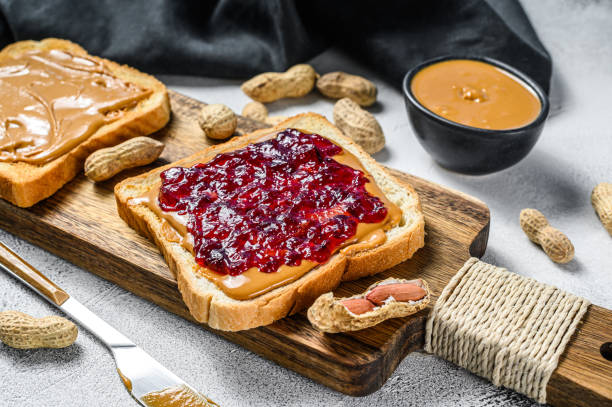 istock Peanut butter sandwich  toast with berry jam.  White background. Top view 1280386930