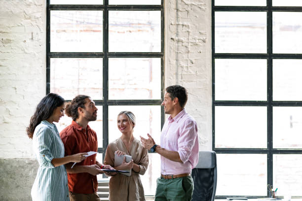 istock Group of Young Business People Chatting at Work 1280387473