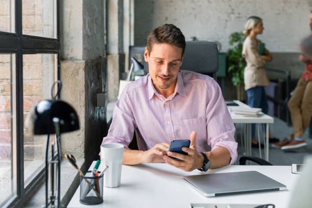 istock Businessman Typing on his Cell Phone 1280387517