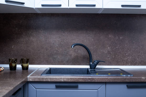 istock countertop with built-in sink made of black artificial stone, kitchen interior 1280388984