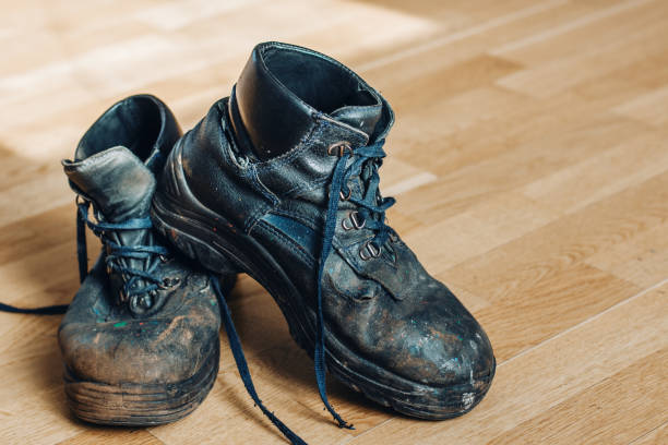 istock Old worn-out workman's shoes. Shoes that require repair or replacement 1280389553