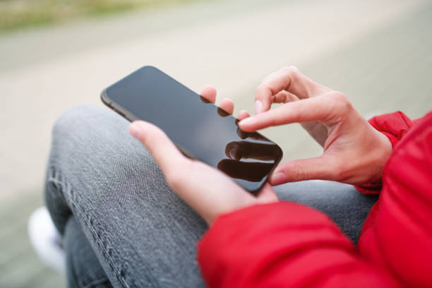 istock Woman uses smartphone outdoors 1280389831