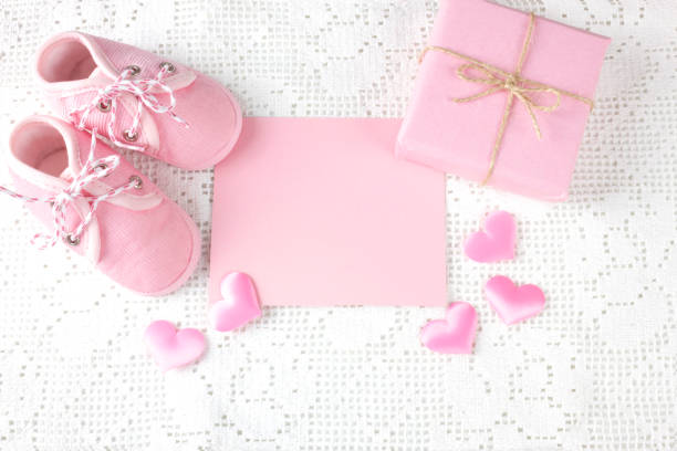 istock Pink newborn booties, gift box and space for your text. Newborn greeting  card. 1280390097